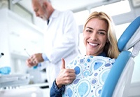 patient giving a thumbs-up in the dental chair 