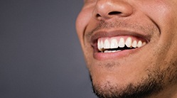 close-up of a man smiling with a full set of white teeth