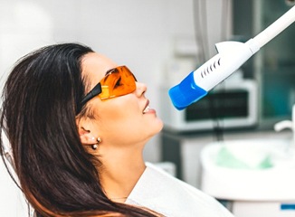 A woman undergoing a teeth whitening procedure.