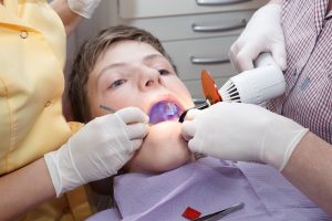 young boy receiving dental sealant