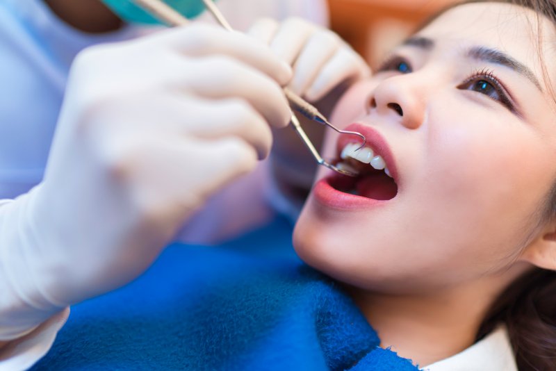 Young woman having checkup with dentist